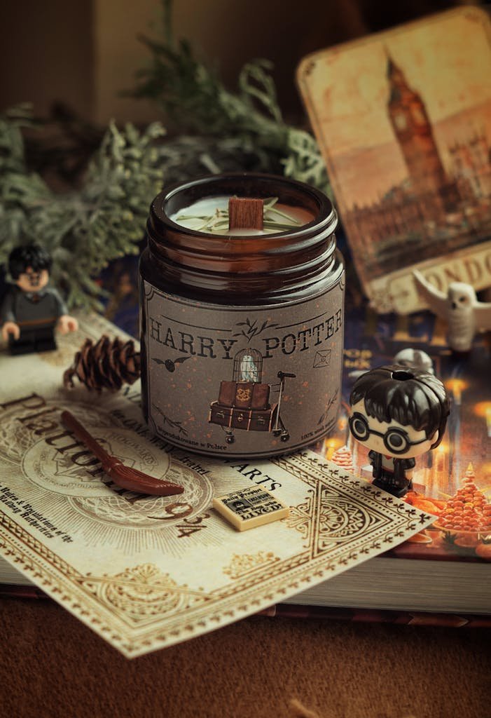 A warm Harry Potter inspired scene with candle, figurines, and magical props, perfect for cozy decor.