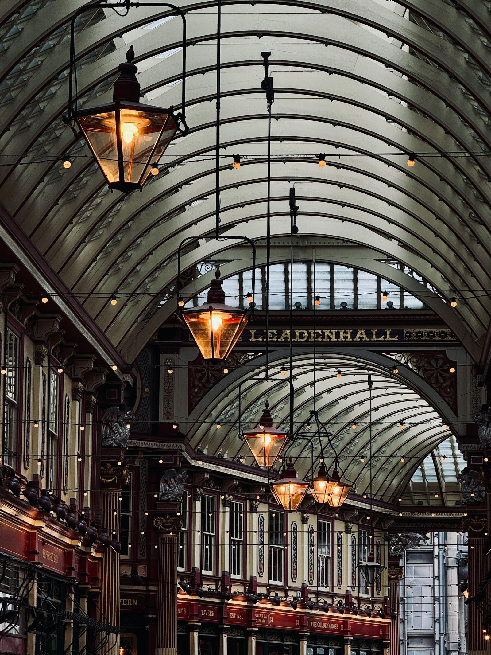 Stunning view of the historic Leadenhall Market in London with ornate architecture and warm lighting.