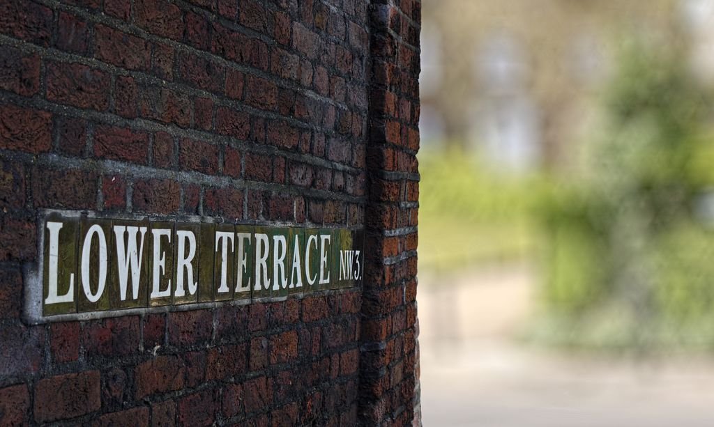Close-up of the 'Lower Terrace NW3' sign on a brick wall in London.